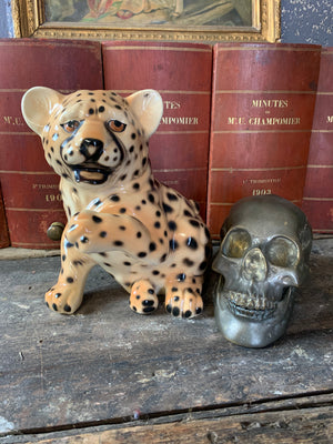 A ceramic mid-century leopard cub statue