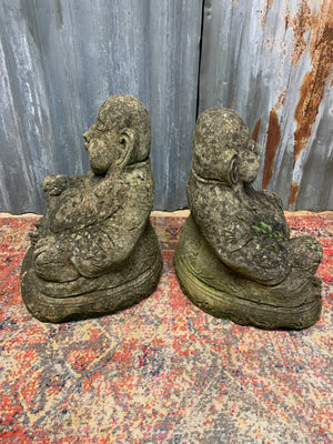 A pair of cast stone laughing Buddhas