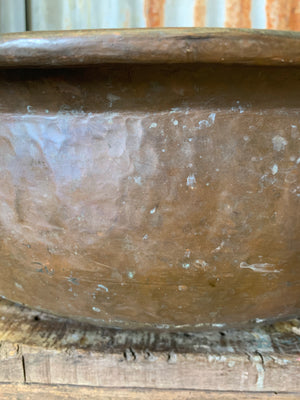A very large hand beaten copper bowl