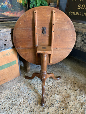 A Georgian oak tilt top table