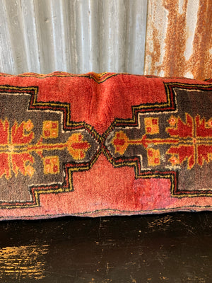 A large Persian carpet cushion