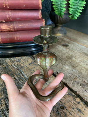 A pair of small Indian or North African cobra candlesticks