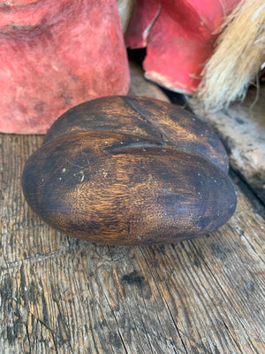 A carved wooden coco de mer specimen