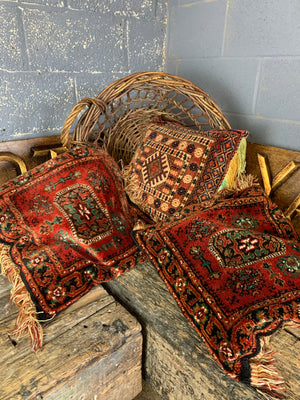 A large red ground Persian carpet cushion - 50cm