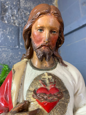 A large 25” plaster statue of Jesus with flaming Sacred Heart