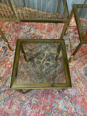 A brass and glass Hollywood Regency nest of tables