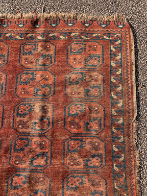 A Persian brown ground rectangular Bokhara rug