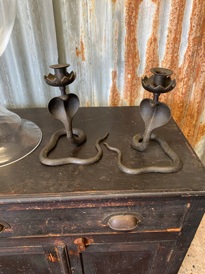 A pair of Indian or North African bronze cobra candlesticks