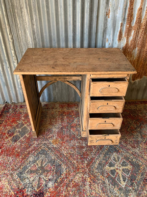 A small sanded oak desk
