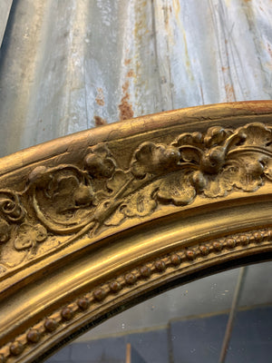 A large 19th century oval gilt mirror