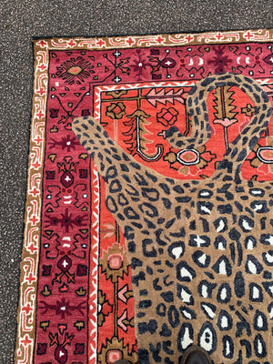 A large Persian style rug with faux taxidermy leopard - 214cm x 153cm
