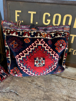 A pair of Persian carpet cushions