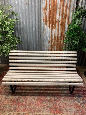 A wrought iron and wood garden bench