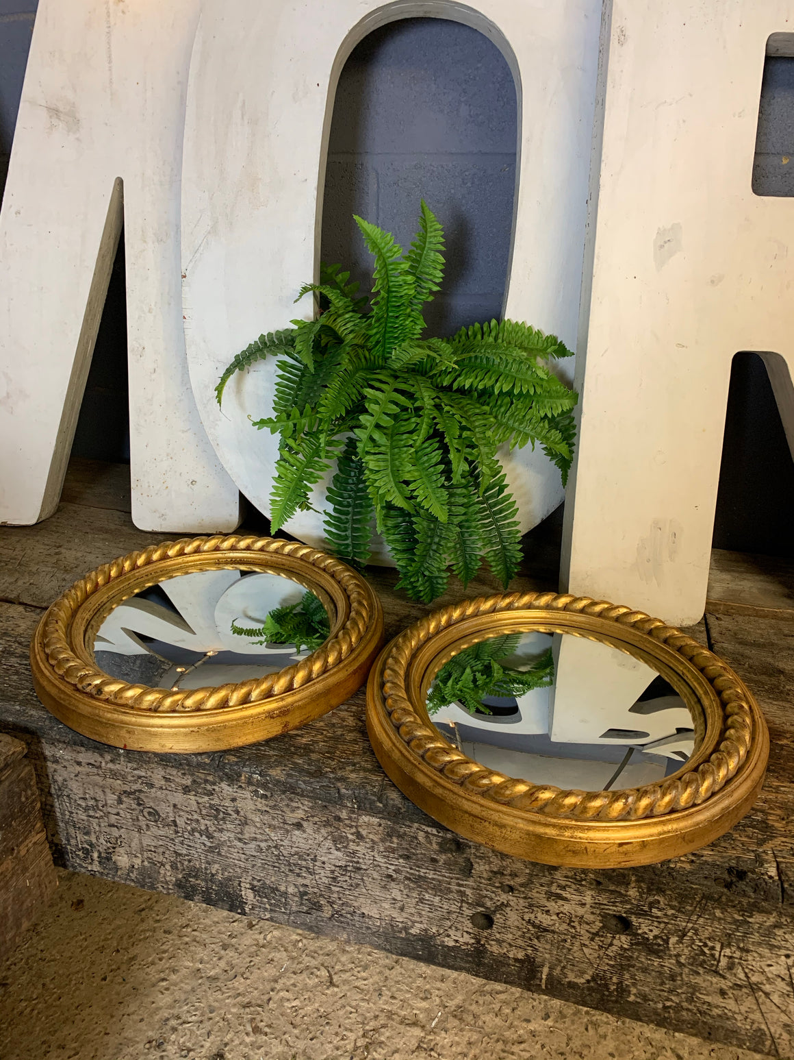 A pair of large gold convex mirrors with rope twist detailing