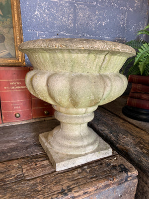 A pair of large cast stone gadrooned urns