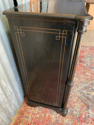 An ebonised display cabinet with glass door