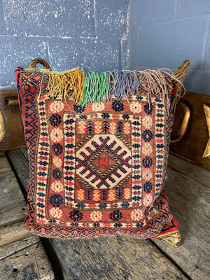 A large red ground Persian carpet cushion - 48cm