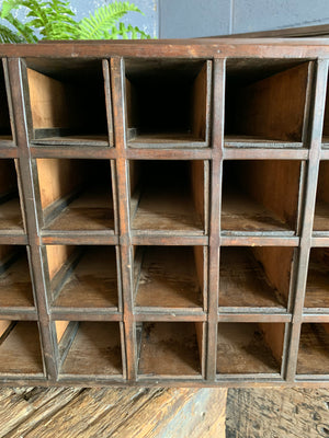 A wooden bank of 48 pigeonholes