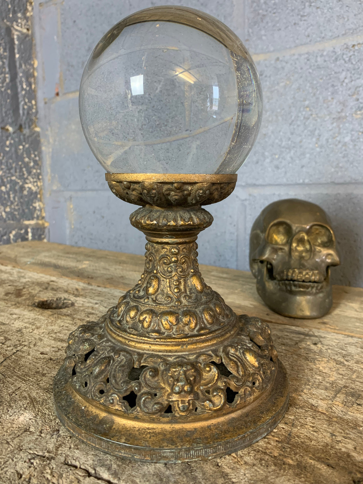 A fortune teller's crystal ball on a gilt leopard head stand