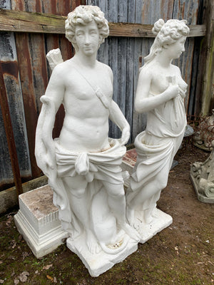 A very large pair of garden statues depicting Apollo and Diana