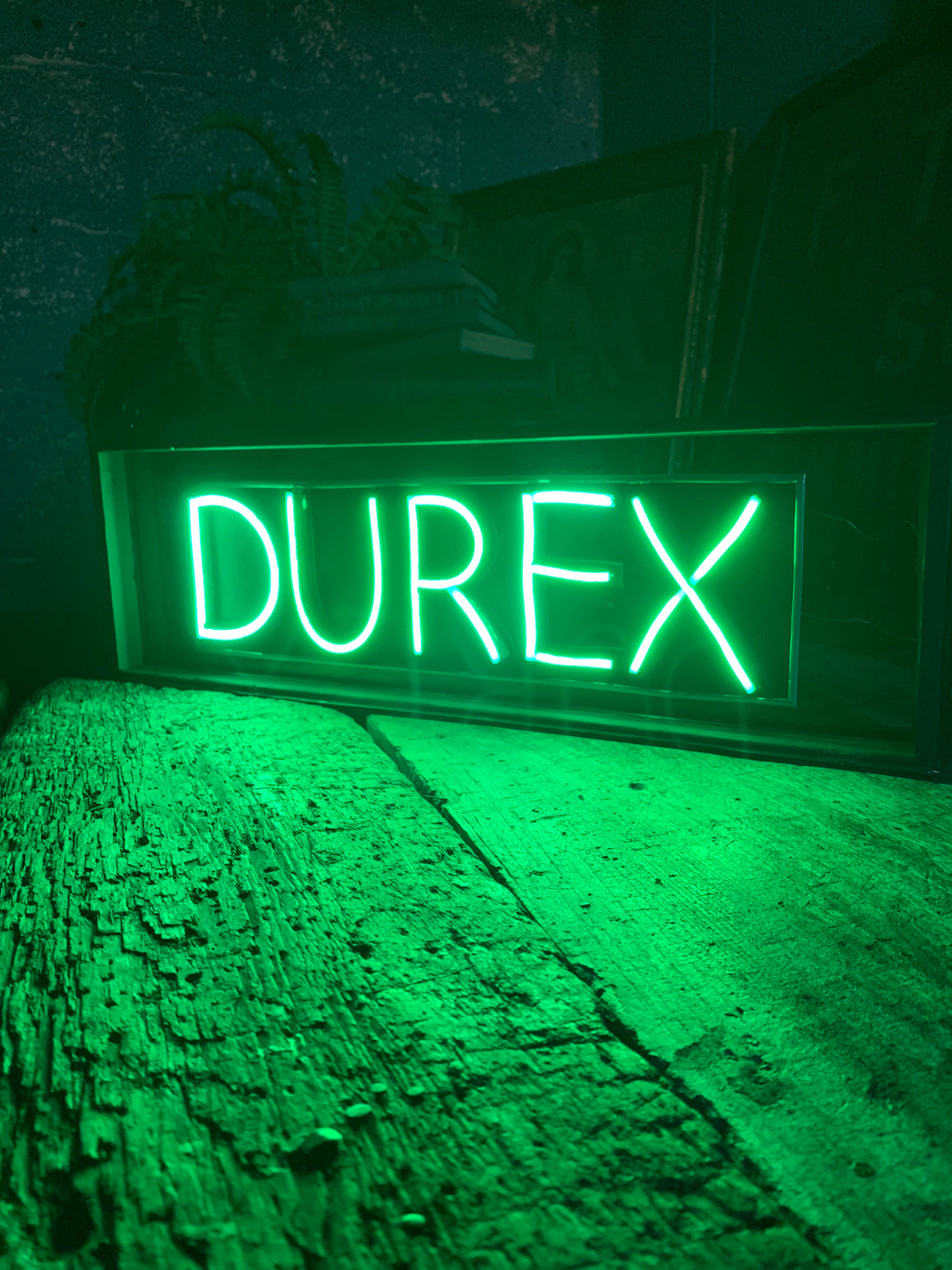 An illuminated Durex sign