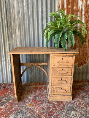 A small sanded oak desk