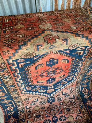 A rectangular red brown ground Persian rug