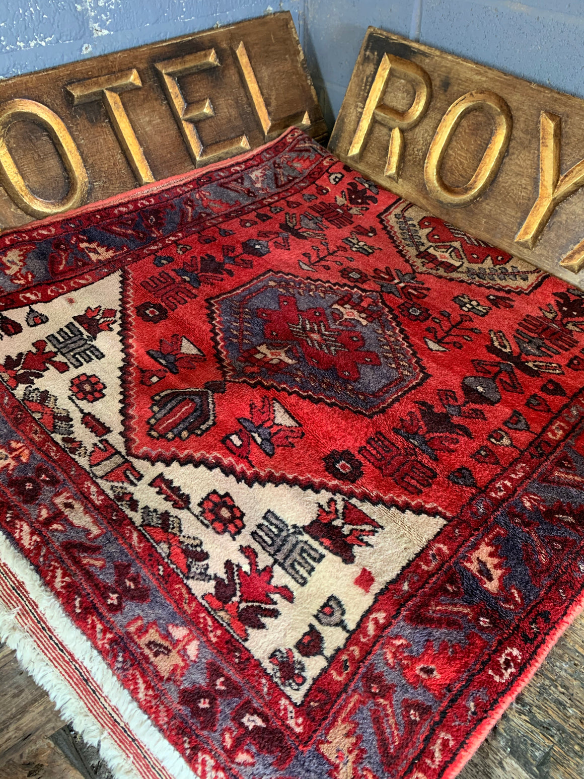 A hand woven Persian red ground rectangular rug