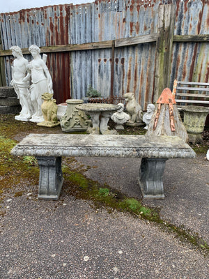 A cast stone garden bench
