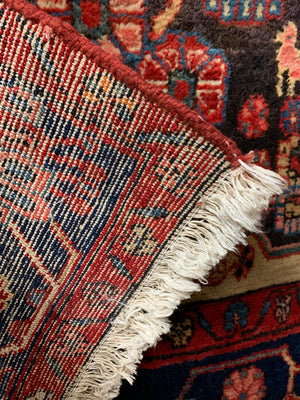 A very large rectangular red ground Persian rug