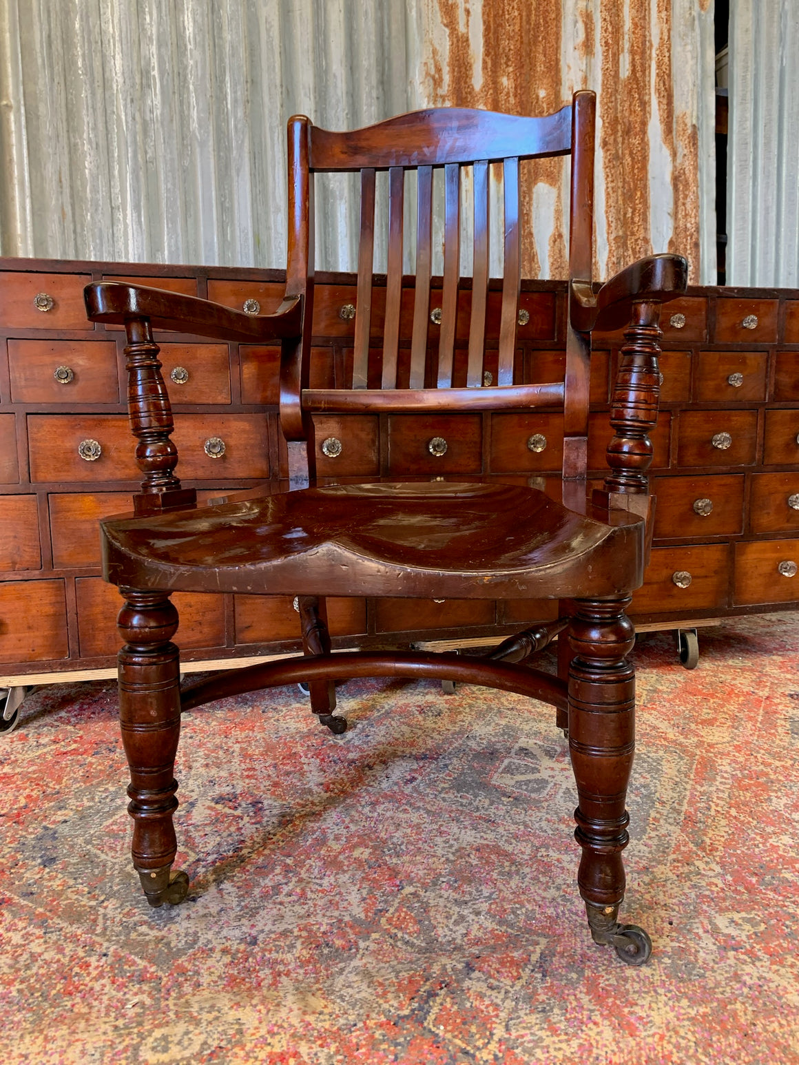 A 19th Century mahogany open arm library chair