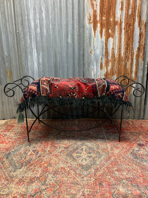 A large rectangular Persian carpet floor cushion