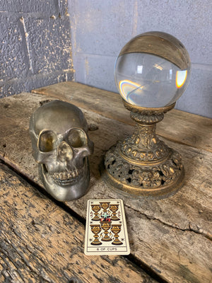 A fortune teller's crystal ball on a gilt leopard head stand