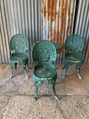 A green garden table and chairs set