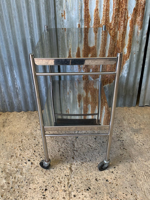 A stainless steel two-tier medical trolley