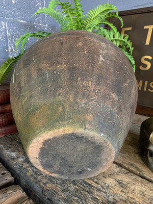 A large terracotta urn with black rim
