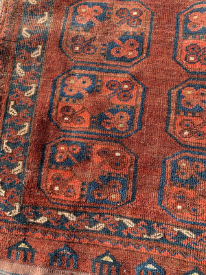 A Persian brown ground rectangular Bokhara rug