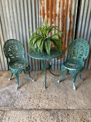 A green garden table and chairs set