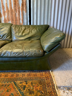 A large 3 seater Modernist Italian sofa in green leather of boat or 'egg' form