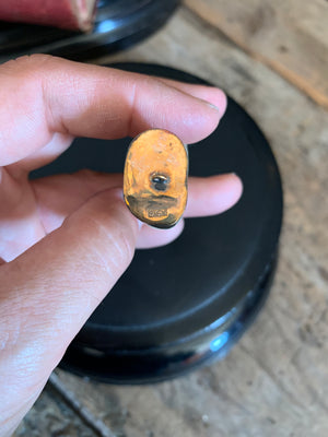 A Raj era lion’s tooth in a gold mount