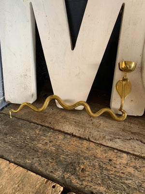 A brass Egyptian Revival style cobra wall sconce