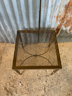 A Hollywood Regency square side table with smoked glass