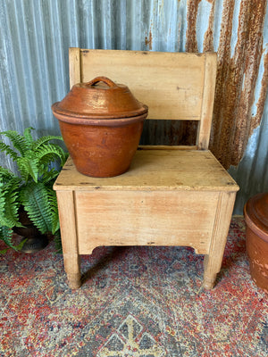 A pine bench seat with storage drawer
