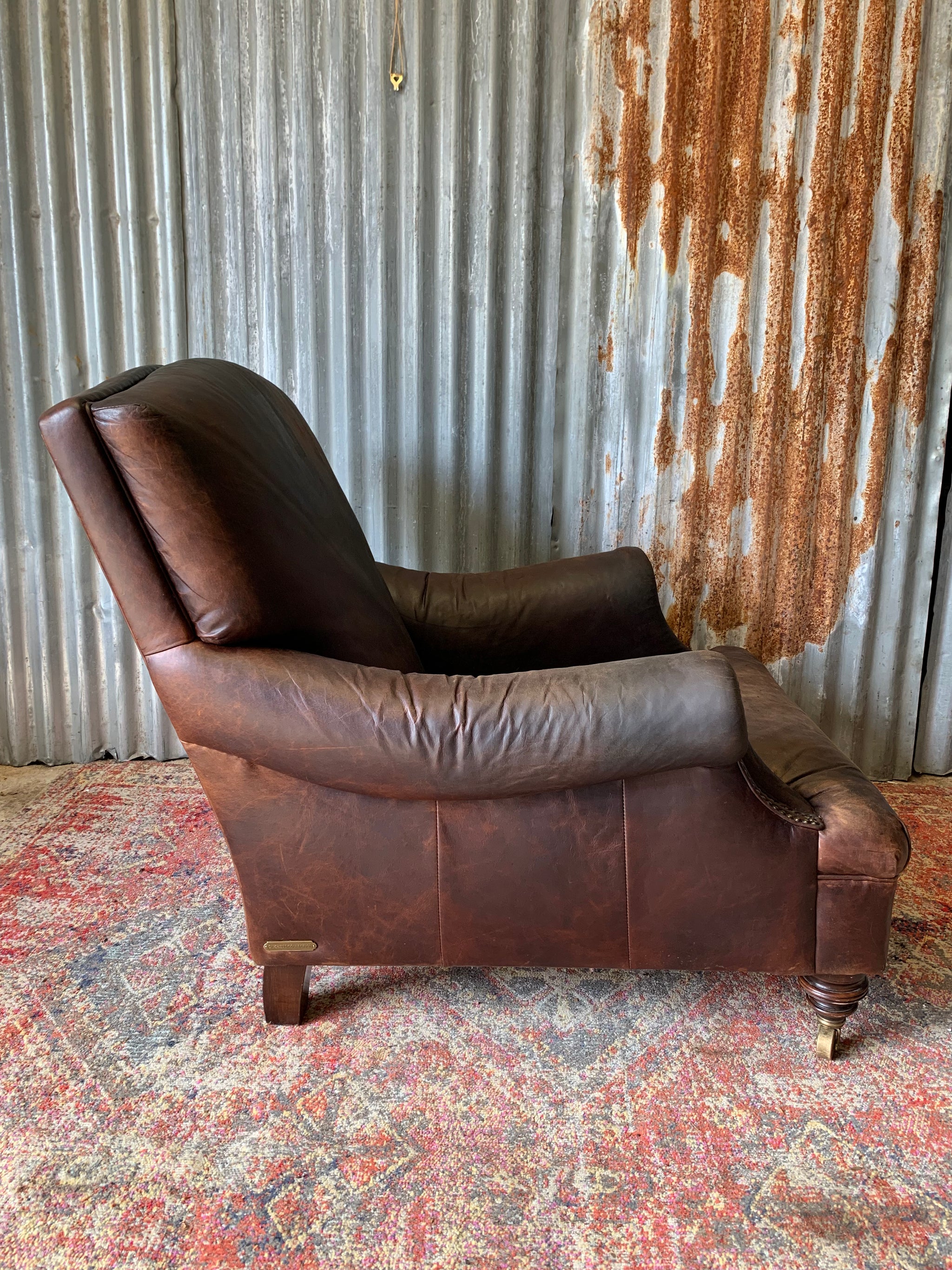 A deep leather armchair raised on castors Belle and Beast Emporium