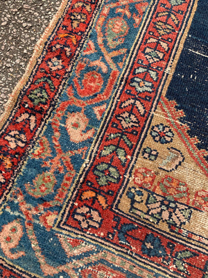 A hand woven Persian red and blue ground large rectangular rug