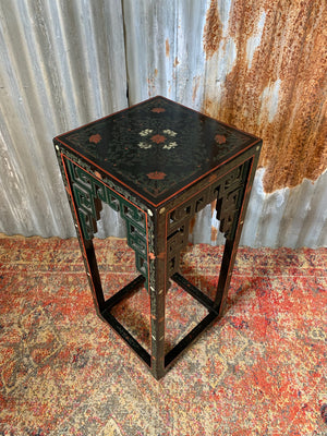 A black lacquered chinoiserie side table