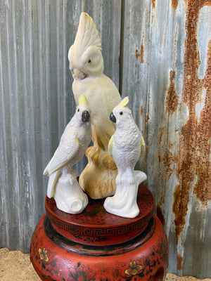 A large white plaster cockatoo statue