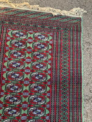 A Persian Bokhara rectangular rug - red/green tones