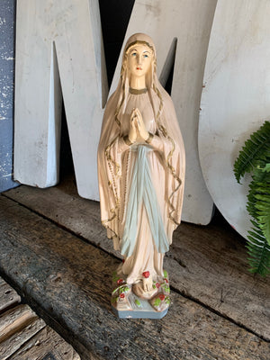 A large plaster Our Lady of Lourdes statue