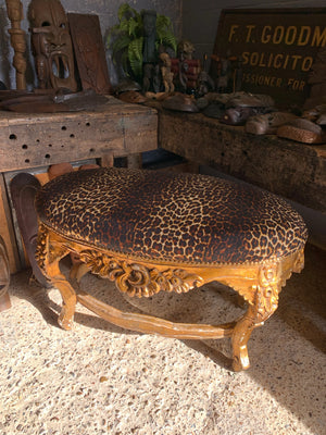 A large rococo style leopard and giltwood bench seat